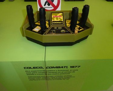 A Combat! on a museum plinth; the label names the AY-3-8700