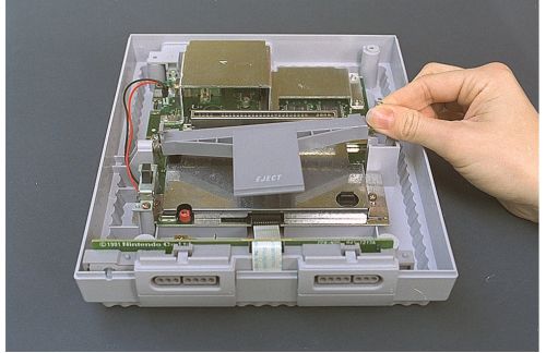 Super NES eject lever removal (Nintendo ASC manual)